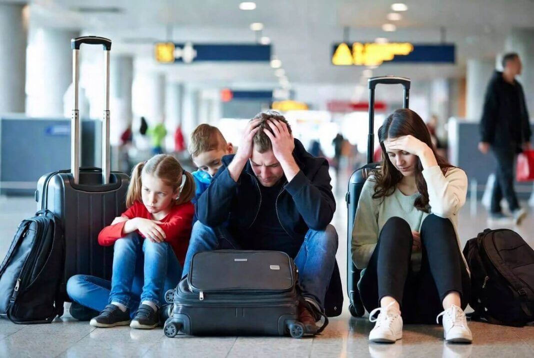 Family at airport looking defeated during delay